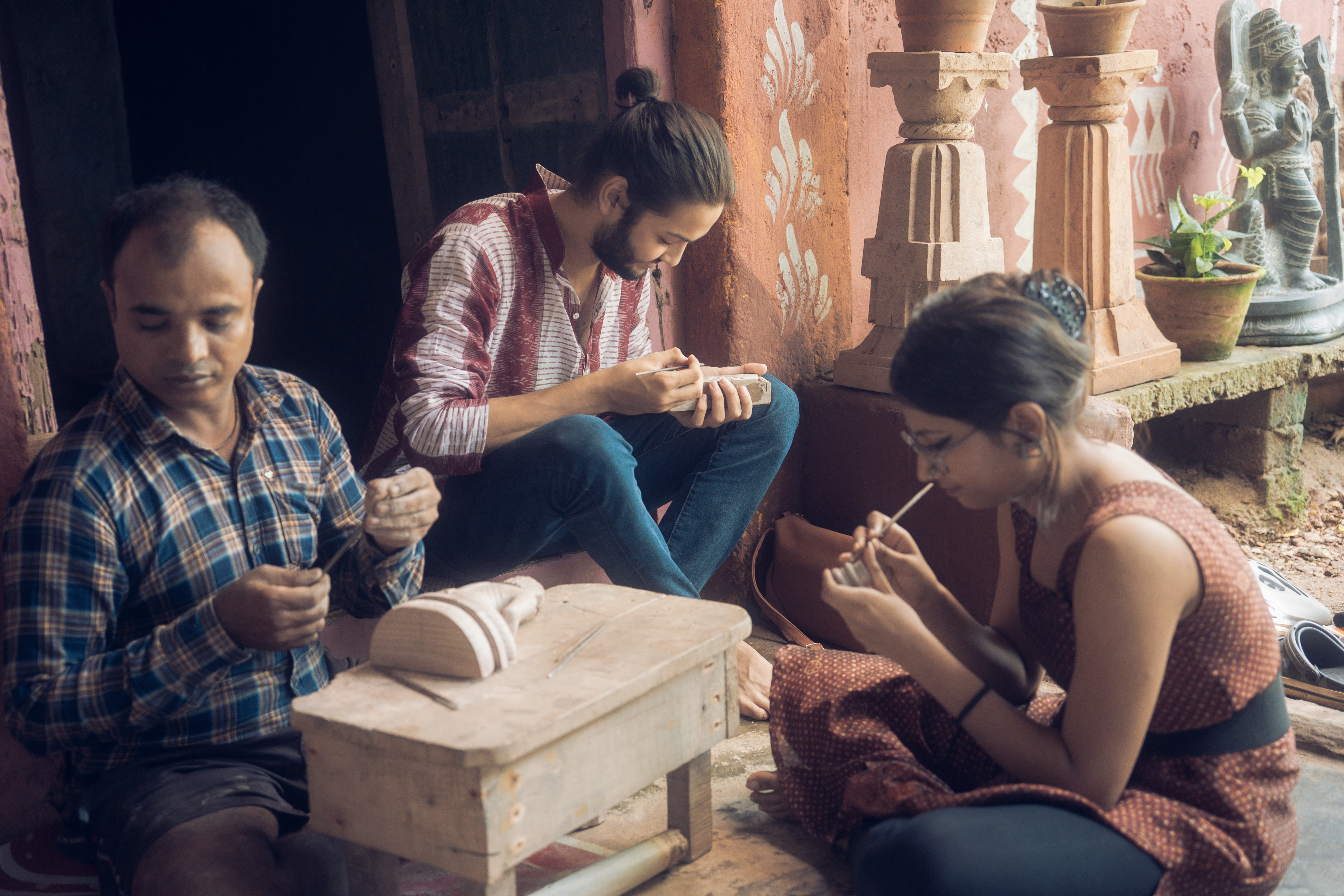 Student working with Konark stone carving artist