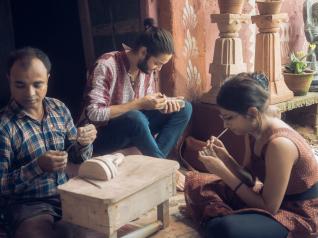 Student working with Konark stone carving artist