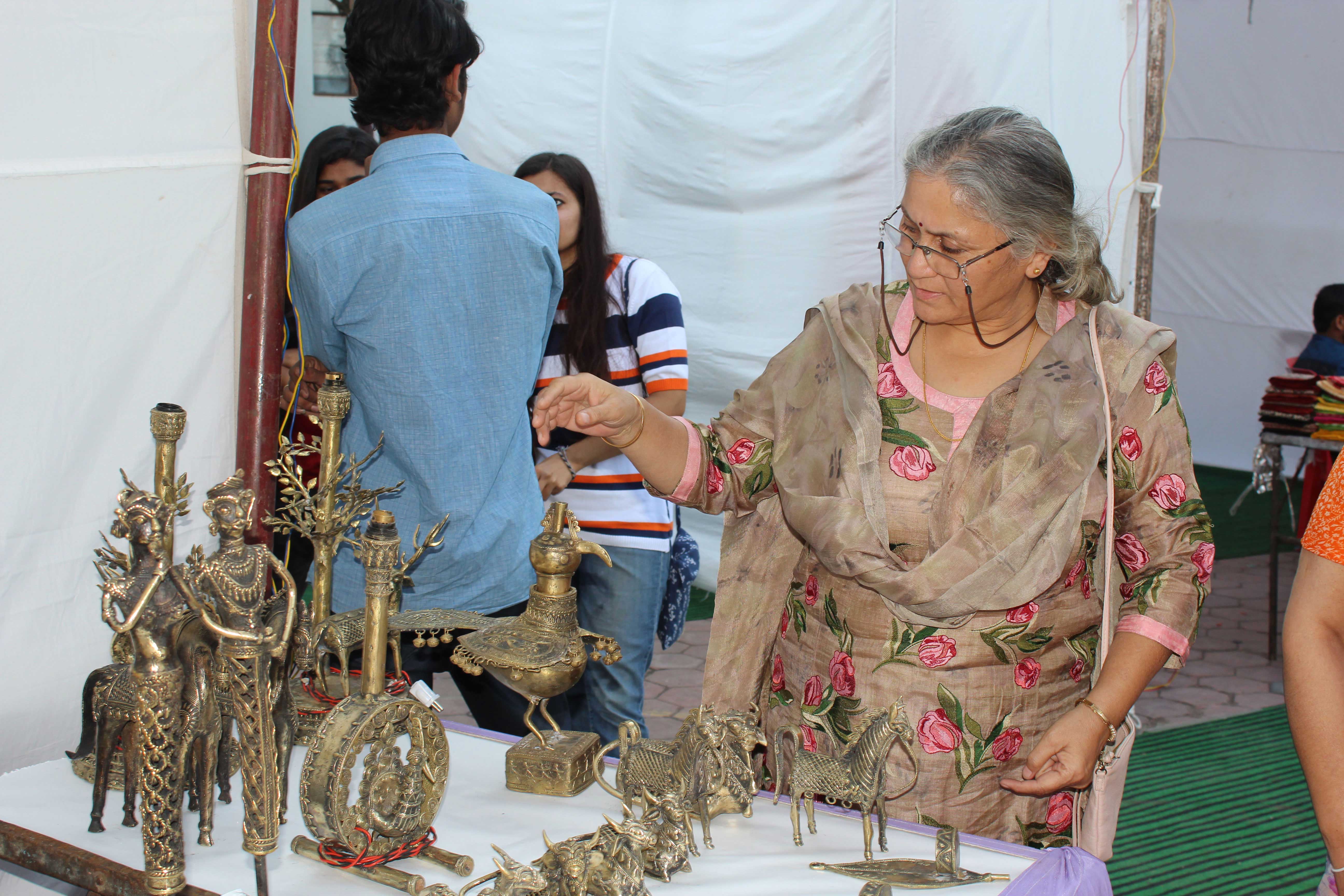 visitor admiring Bell metal craft